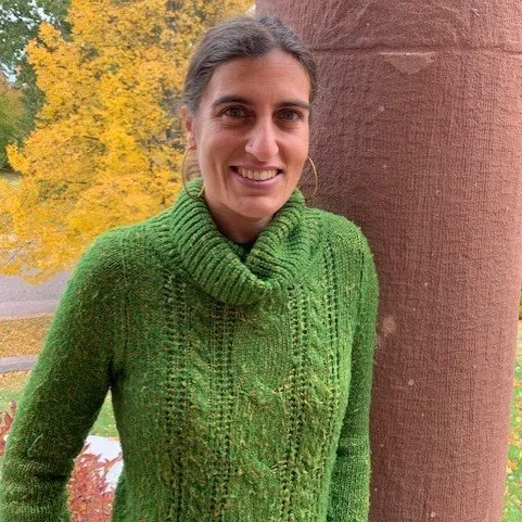 Shyam Devi Gray standing outside the library smiling