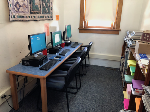 3 computers sitting adjacently on a table